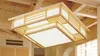 A Japanese-style wooden ceiling lamp with integrated LED lighting is shown installed in a room with exposed wooden beams. Náhled obrázku produktu