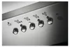 A close-up view of the control panel of a kitchen appliance, likely a range hood, showing various buttons and symbols. Voir les images du produit