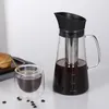 A cold brew coffee maker and a glass of coffee are on a table. Náhled obrázku produktu