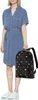 A person stands against a white background holding a backpack. Produktbild-Vorschau