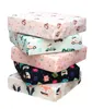 A stack of five children's booster seat cushions with different patterns. Produktbild-Vorschau