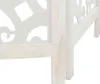 A close-up view of the bottom corner of a white wooden room divider with decorative cutouts. Podgląd zdjęcia produktu