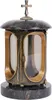 A gravestone lantern with a cross on top, made of dark stone and gold-colored metal. Náhľad obrázku produktu
