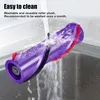 A purple vacuum cleaner roller brush is being rinsed under running water in a sink. Produktbild-Vorschau