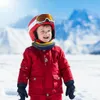 A young child dressed in winter ski gear smiling in a snowy mountain environment. Náhled obrázku produktu