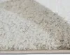 A close-up view of a rug with a geometric pattern. Produktbild-Vorschau