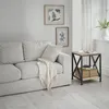 A living room scene with a sofa and a side table. Voir les images du produit