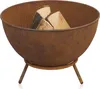 A rusty metal fire pit with three legs, containing several pieces of firewood. Produktbild-Vorschau