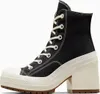 A black high-top sneaker with a thick cream-colored platform and heel, shown from the side against a white background. Produktbild-Vorschau