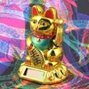 A golden Maneki-neko (lucky cat) figurine with a solar panel on its base, set against a colorful, abstract patterned background. Produktbild-Vorschau