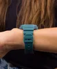 Close-up of a person's wrist wearing a teal Casio G-Shock watch. Produktbild-Vorschau