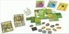 A board game with various components laid out on a white background. Produktbild-Vorschau