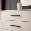 A close-up view of the top drawers of a dresser with black handles. Produktbild-Vorschau