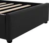 A close-up view of the side and corner of a black upholstered bed frame, showing the wooden slats of the mattress support. Produktbild-Vorschau