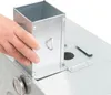 A hand is shown adjusting a metal component on a silver appliance. Náhled obrázku produktu