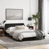A bedroom scene with a black bed frame, bedding, nightstands, and decor. Podgląd zdjęcia produktu