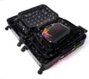 Several black suitcases of different sizes are nested inside each other, with the smallest one open and containing a smaller black case with a colorful paint splatter design. Náhled obrázku produktu