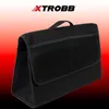 A black felt trunk organizer with mesh pockets and a handle, set against a gradient background. Náhled obrázku produktu