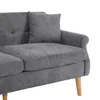 A close-up view of a gray sofa's seat and armrest, with a single throw pillow. Produktbild-Vorschau
