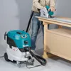 A person is using a circular saw on a workbench, with a vacuum cleaner connected to the saw. Produktbild-Vorschau