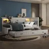 A white daybed with a pull-out trundle bed is set up in a child's bedroom with blue walls and a decorative rug. Produktbild-Vorschau