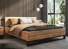 A modern bedroom with a wooden bed frame, bedding, and a large window. Náhled obrázku produktu