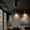 A modern living room with large windows, sofas, and ceiling lights. Náhled obrázku produktu
