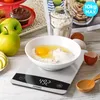 A digital kitchen scale with ingredients for baking. Produktbild-Vorschau