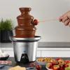 A chocolate fountain with a strawberry being dipped into it, surrounded by various treats. Anteprima dell’immagine prodotto