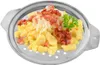 A food product, likely dumplings, served in a metal grater. Produktbild-Vorschau