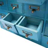 A close-up, slightly angled view of a bright blue wooden multi-drawer organizer cabinet. Produktbild-Vorschau