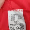 A close-up of a clothing label showing material composition and care instructions. Produktbild-Vorschau