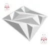 A white 3D geometric wall panel is shown against a white background, with logos in the top left and bottom right corners. Produktbild-Vorschau