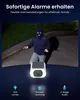 A person in a ski mask is shown in the background, while a security camera is in the foreground. Produktbild-Vorschau