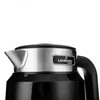 A close-up shot of the top part of a black and silver electric kettle, focusing on the spout and the brand logo. Podgląd zdjęcia produktu
