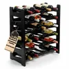 A black plastic wine rack filled with bottles of wine, with a tag hanging from the side. Produktbild-Vorschau