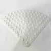A white, quarter-circle shaped shower mat with raised bumps is laid flat on a white background. Voir les images du produit