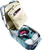 An open backpack with clothing and a tablet inside. Voir les images du produit
