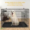 A white dog sits inside a black metal dog crate, with text overlays in yellow. Produktbild-Vorschau