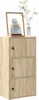 A light brown wooden cabinet with three doors, decorated with a framed picture and a plant in a vase on top. Podgląd zdjęcia produktu