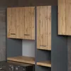 A close-up view of a bathroom cabinet set with a wood-grain finish and gray matte accents, positioned above a washing machine. Produktbild-Vorschau