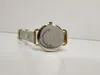 The back of a watch is shown on a white surface. Náhled obrázku produktu