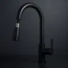 A black kitchen faucet with a pull-out spray head is shown against a dark background. Produktbild-Vorschau