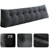 A long, triangular, button-tufted backrest pillow for a bed or sofa, shown against a white background. Smaller inset images show a side pocket with a phone, a close-up of a button, and a zipper. Produktbild-Vorschau