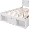 A close-up, angled view of a white wooden bed frame with storage drawers underneath. Podgląd zdjęcia produktu