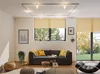 A modern living room with a dark gray sofa, yellow cushions, and a coffee table. Produktbild-Vorschau