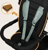 Close-up view of a child's safety harness and handlebar on a stroller or tricycle. Produktbild-Vorschau