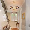 A hallway with a staircase, a bench, a rug, and a door with decorative glass panels. Two ceiling lights are visible. Produktbild-Vorschau