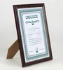 A framed certificate is displayed on a stand against a white background. Produktbild-Vorschau