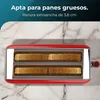 A red toaster with four slices of bread inside, set against a marble-like background. Voir les images du produit